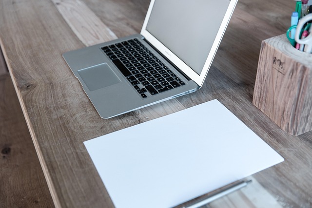 person using AI planning tool on laptop at kitchen table with family